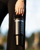 Person holding a Venova water bottle with a blurred background